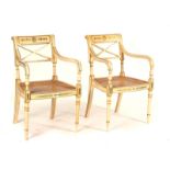 A PAIR OF REGENCY STYLE PARCEL GILT CREAM PAINTED OPEN ARMCHAIRS (2)
