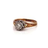 A GOLD AND PLATINUM DIAMOND SINGLE STONE RING