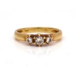 A GOLD AND DIAMOND THREE STONE RING
