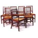IN THE MANNER OF HEALS; A SET OF SEVEN OAK FRAMED STICK BACK CHAIRS (7)