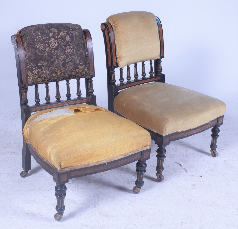A PAIR OF VICTORIAN EBONISED LOW NURSING CHAIRS