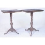 A PAIR OF MODERN CAST IRON PUB TABLES WITH RECTANGULAR HARDWOOD TOPS