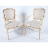 A PAIR OF LOUIS XV STYLE WHITE PAINTED OPEN ARMCHAIRS