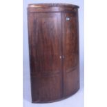 A GEORGE III INLIAD MAHOGANY BOWFRONT HANGING CORNER CUPBOARD