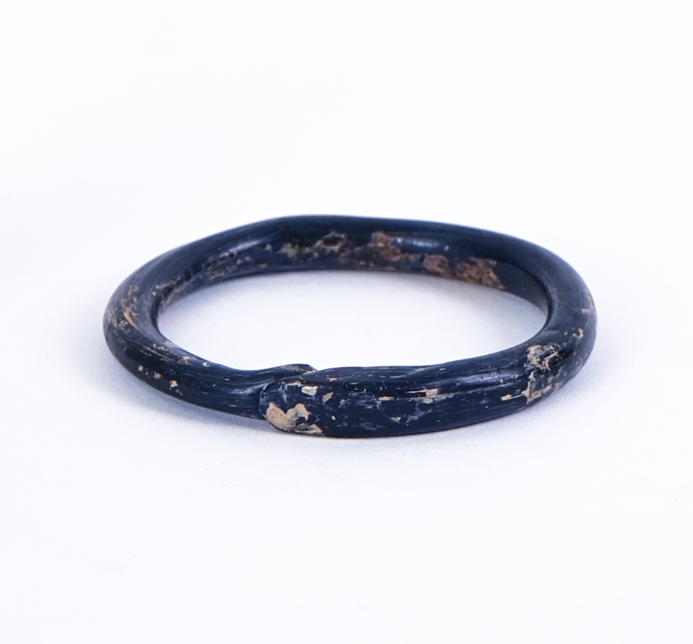 A ROMAN BLUE GLASS BANGLE AND A BRONZE AMULET, POSSIBLY INDIAN (2) - Image 2 of 3