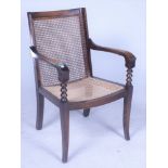 AN EARLY 20TH CENTURY MAHOGANY AND CANEWORK OPEN ARMCHAIR