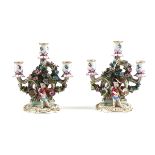 A PAIR OF MEISSEN PORCELAIN THREE-LIGHT FIGURAL CANDLESTICKS