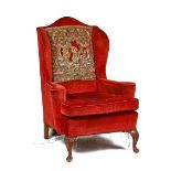 A GEORGE II STYLE WINGBACK ARMCHAIR