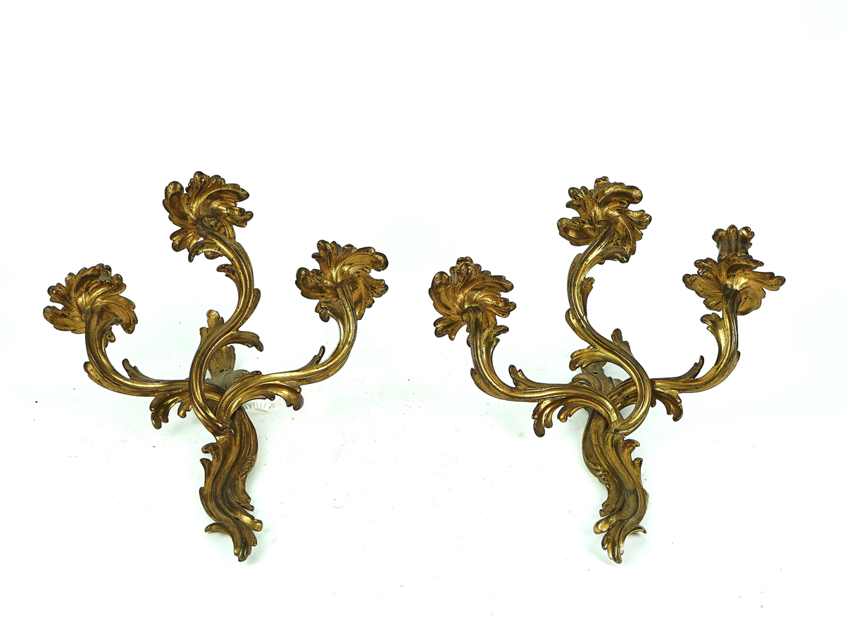 A PAIR OF ROCOCO STYLE GILT-METAL THREE-LIGHT WALL APPLIQUÉS