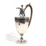 A GEORGE III SILVER HOT-WATER JUG