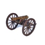 A BRONZE MODEL CANNON ON FIELD CARRIAGE