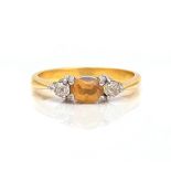 A GOLD, TOPAZ AND DIAMOND THREE STONE RING