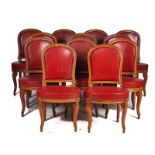 A SET OF TWELVE BEECH FRAMED LOUIS XVI STYLE, RED LEATHER UPHOLSTERED DINING CHAIRS (12)