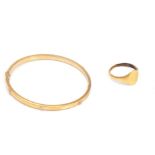 A GOLD BANGLE AND A 9CT GOLD SIGNET RING (2)