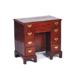 A GEORGE III MAHOGANY KNEEHOLE WRITING DESK