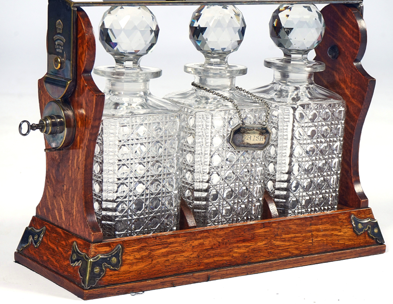BETJEMANN’S PATENT; A LATE 19TH CENTURY SILVER PLATE AND OAK THREE BOTTLE TANTALUS - Image 4 of 4