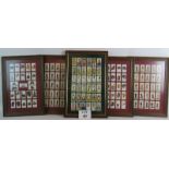 Four framed sets of Players cigarettes cards including two sets of Military head dress and two sets