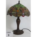 A good quality Tiffany style dragonfly table lamp with stained glass shade and cast bronzed base.