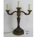 An early 20th Century Gothic style carved wood and gilded gesso three branch electric candelabra