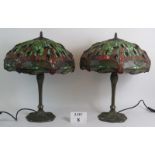 A pair of good quality Tiffany style dragonfly table lamps with stained glass shades and cast Art