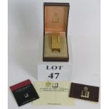 A gold plated Dunhill Rollagas cigarette lighter with original box flints and documents.