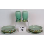 A pair of Clarice Cliff 663 pattern vases and a pair of 39A pattern salad drainer's and plates.