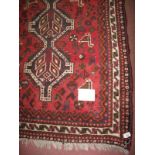 A mid 20th century Shiraz rug, three tie