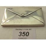 A silver envelope shaped card case with