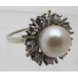 An unmarked white metal pearl and diamon