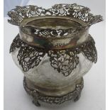 A heavily engraved crystal bowl on a sil