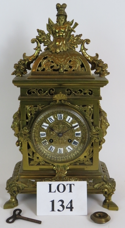 An ornate French brass mantle clock by J