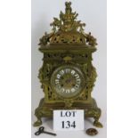 An ornate French brass mantle clock by J