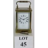 A brass cased French made carriage clock by Benetfink & Co of London with glazed case and white