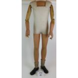 A vintage plaster and wood boy shop mannequin circa 1920's, adjustable beech wood arms,