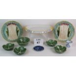 A pair of Majolica asparagus plates, a similar hand decorated bread plate,