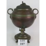 A Regency copper and brass samovar with lion head and griffin handles and a sphinx terminal to lid.
