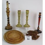 A pair of painted wooden candlesticks, a single hand painted candlestick with geometric patterns,