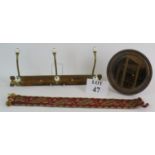 A 19th Century 3 hook brass coat rack with porcelain terminals 45cm long,