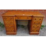 A 19th century mahogany break front writing kneehole desk having a configuration of nine drawers