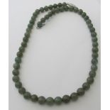 A jade bead necklace with silver clasp,
