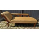 A rustic oak framed chaise longue in the