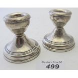 A pair of silver stub candlesticks, app