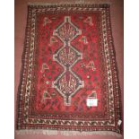 A mid 20th century Shiraz rug, three tie