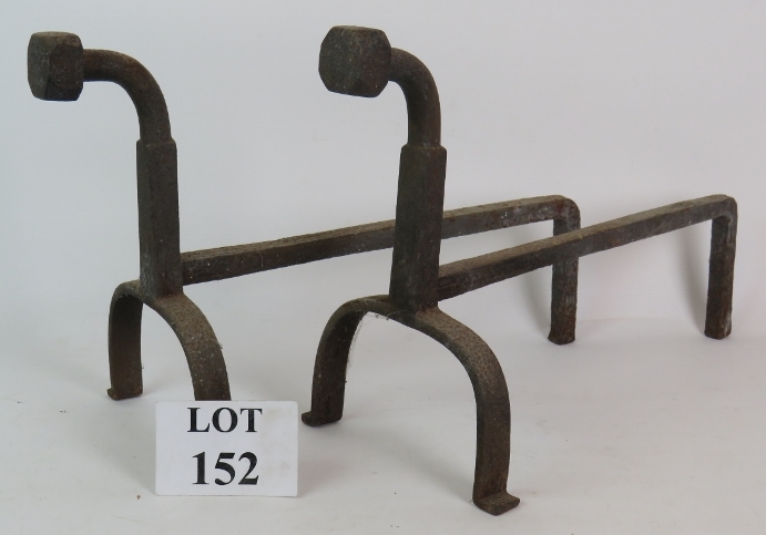 A large pair of heavy wrought iron fire