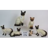 Six pottery Siamese cat figurines includ