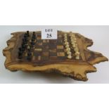 A hand made burr wood chess board with turned wood chess set, each colour having its own drawer.