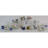 A collection of 33 mainly antique ceramic egg cups including Moorcroft, Wedgwood, Booths, Mintons,