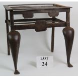 A forged steel 19th Century fireplace footman or trivet with splayed legs and steel rivet fixings.