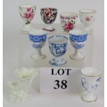 Eight mainly hand decorated porcelain egg cups including Royal Worcester,