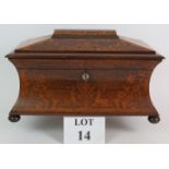 An inlaid Victorian rosewood concave sarcophagus tea caddy with ornate floral inlay featuring two